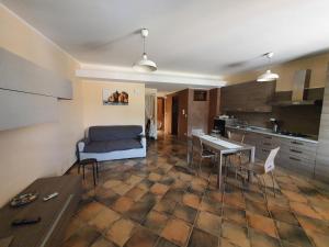 a living room with a couch and a table at Casa La Ferula apt3 vicino al mare e Taormina con terrazza panoramica in SantʼAlessio Siculo +12 photos