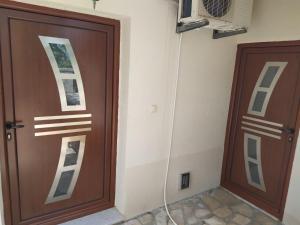 a pair of wooden doors in a room at Drakulovic apartmani in Herceg-Novi