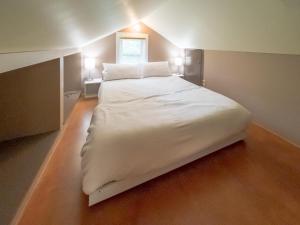a large white bed in a room with a window at Base Camp in Bend +30 photos