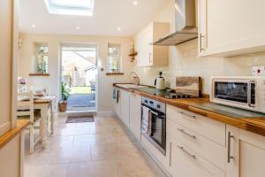 a kitchen with white cabinets and a counter top at Fair Place in Hornsea
