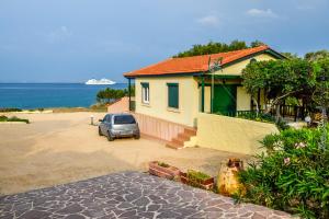 a house with a car parked in front of it at Villa Corali in Karfas