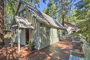 a wooden deck with a building with a patio at Cozy Shaver Lake Cabin Less Than 1 Mi to Shaver Lake! in Shaver Lake