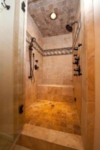 a bathroom with a shower with a tiled floor at The Ranch 43 Latigo Road in Durango