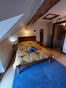 a bedroom with a bed with a blue rug at Annie’s Cottage in Llanrhaeadr-ym-Mochnant
