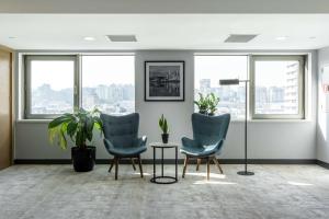 a room with two chairs and a table with plants at Radisson Hotel Baku in Baku