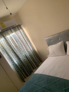 a small bedroom with a bed and a window at Marbella1 in Los Frailes