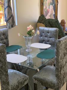 a dining room with a glass table and chairs at Marbella1 in Los Frailes