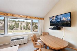 a dining room with a table and a large window at Tamarron Lodge Loft 510 in Durango