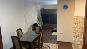 a dining room with a black table and chairs at Arni apartments in Donja Vrežina