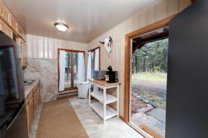 a small room with a kitchen with a door to a yard at 151 CR 200 1 Bedroom Cabin in Durango
