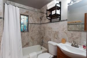 a bathroom with a sink and a toilet and a tub at 151 CR 200 1 Bedroom Cabin in Durango