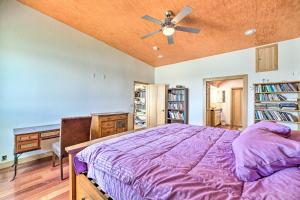 a bedroom with a purple bed and a ceiling fan at Lakefront Country Home with Waterslide and Trampoline! in Wheatland