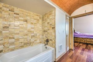 a bathroom with a white tub in a room at Lakefront Country Home with Waterslide and Trampoline! in Wheatland +33 photos