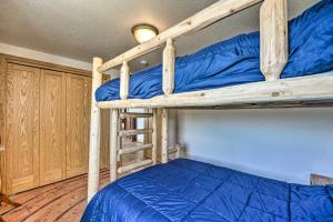 a bedroom with two bunk beds with blue sheets at Lakefront Country Home with Waterslide and Trampoline! in Wheatland