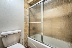 a bathroom with a toilet and a glass shower at Lakefront Country Home with Waterslide and Trampoline! in Wheatland