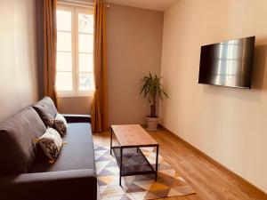 a living room with a couch and a table at Maison De La Tour in Saint-Émilion