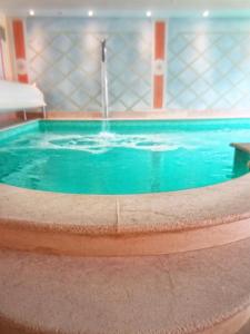 a large swimming pool with a water fountain at Ca' Tessera Venice Airport in Tessera