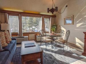 a living room with a couch and a table at Tamarron Lodge Loft 314 in Durango