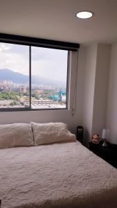 เตียงในห้องที่ HABITACION PRIVADA EN HERMOSO APARTAMENTO EN EL POBLADO-CIUDAD DEL RIO