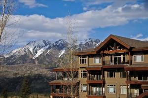 a large building with mountains in the background at Peregrine Point 205 in Durango Mountain Resort
