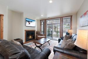 a living room with a couch and a fireplace at Peregrine Point 205 in Durango Mountain Resort