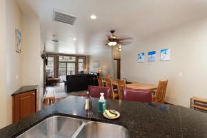 a kitchen and living room with a sink and a table at Peregrine Point 205 in Durango Mountain Resort