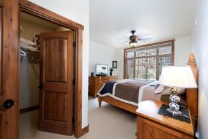 a bedroom with a bed and a table with a lamp at Peregrine Point 205 in Durango Mountain Resort +23 photos
