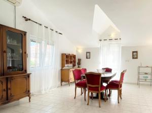 a dining room with a table and chairs and a tv at Apartments Kampe in Kotor