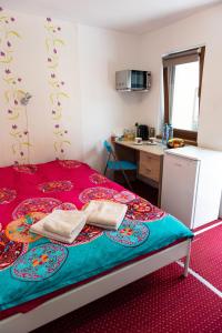 a bedroom with a bed with two towels on it at Center Walking Apartment and Room in Bucharest