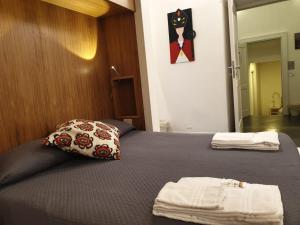 a bedroom with a bed with two towels on it at Napoli Belle Arti in Naples