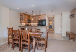 a kitchen and dining room with a table and chairs at The Seasons Unit 205 in Avon