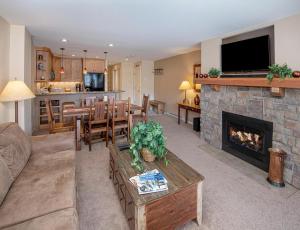 a living room with a couch and a fireplace at The Seasons Unit 205 in Avon