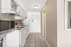 uma cozinha com electrodomésticos brancos e piso em azulejo em Driftwood 51009 em Myrtle Beach