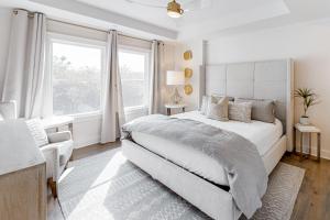 a white bedroom with a large bed and a window at Crossings at Watersound B102 in Inlet Beach