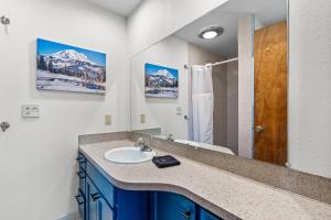 a bathroom with a sink and a shower at Otter River Lodge in Bend +29 photos