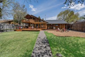 a house with a porch and a yard at Otter River Lodge in Bend