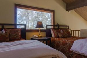a bedroom with two beds and a window at Tamarron PineCone 858 in Durango +48 photos