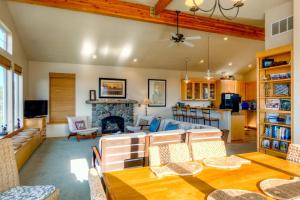a living room with a table and a fireplace at Twin Rocks Haven in Rockaway Beach