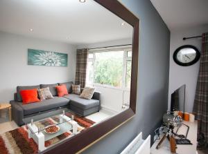 a large mirror in a living room with a couch at So-Cosy Cityside in Belfast