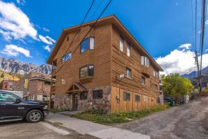 a wooden house with a car parked in front of it at 225 6th Avenue 4 in Ouray