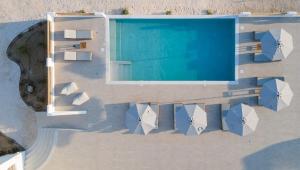 an overhead view of a swimming pool with umbrellas at Naxos Earth Suites in Mikri Vigla