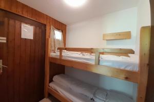 a small room with two bunk beds in it at Apartment on the slopes in La Clusaz
