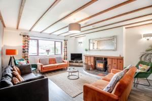a living room with couches and a fireplace at Stiniog Lodge in Blaenau-Ffestiniog