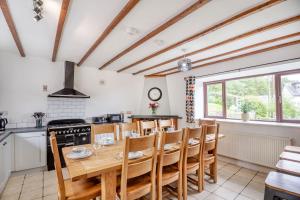 a kitchen with a wooden table and some chairs at Stiniog Lodge in Blaenau-Ffestiniog