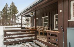 a porch of a wooden house with snow on it at Stunning Home In Tynset With House A Mountain View in Tynset