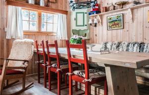 チュンセットにあるStunning Home In Tynset With House A Mountain Viewのダイニングルーム(木製テーブル、椅子付)