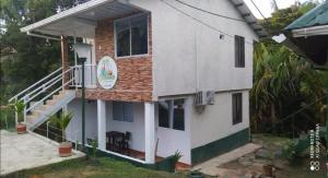 a white house with a staircase in front of it at VIDAMAR, JUANCHACO. LADRILLEROS, LA BARRA in Playa Ladrilleros