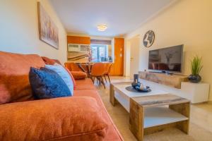 a living room with a couch and a table at Apartments Laganini in Novi Vinodolski