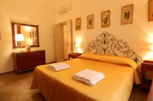 a bedroom with a bed with two towels on it at 3House in Rome