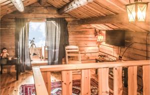 a wooden cabin with a balcony and a television at Nice Home In stby With Wifi And 4 Bedrooms in Østby